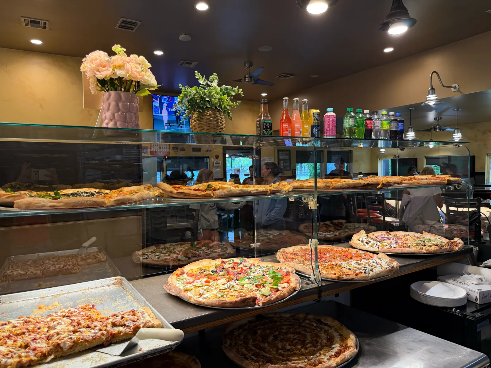 Slice display case full of pizzas at Antonio's Pizza Belchertown