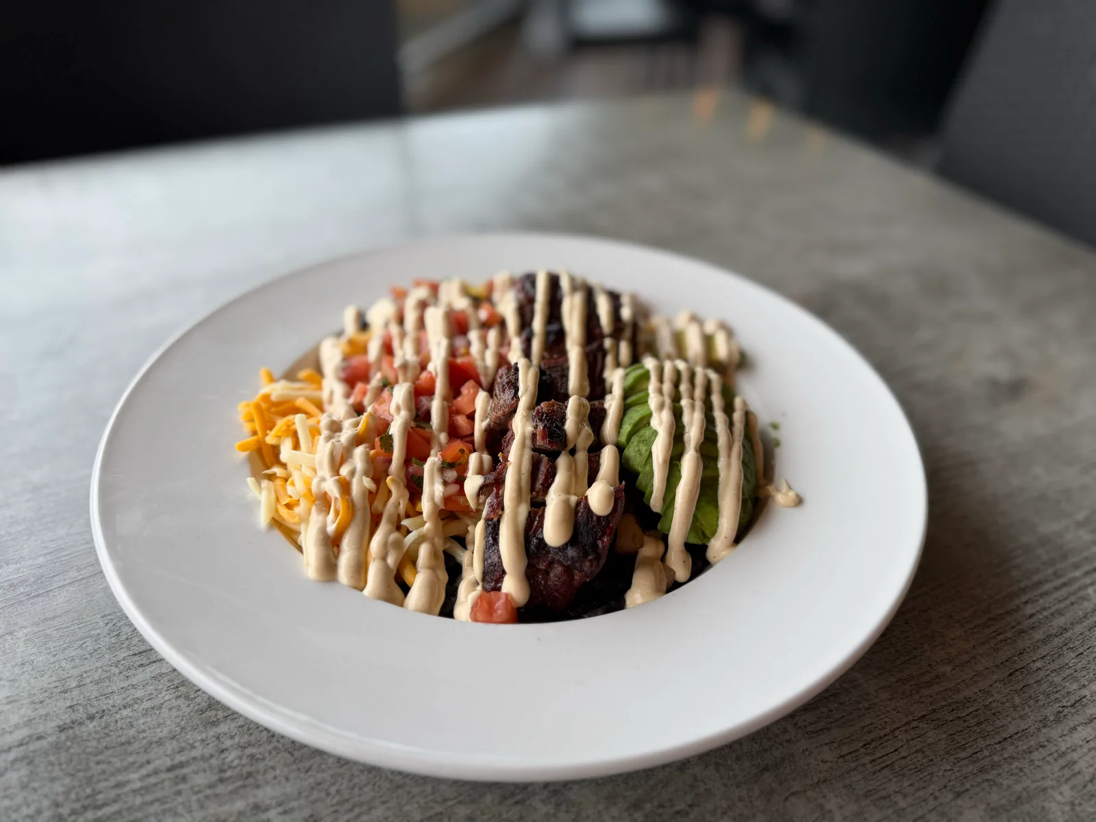 Burrito bowl with roasted corn salsa, black beans, pico, jack cheese and spicy crema at Antonio's Pizza Belchertown