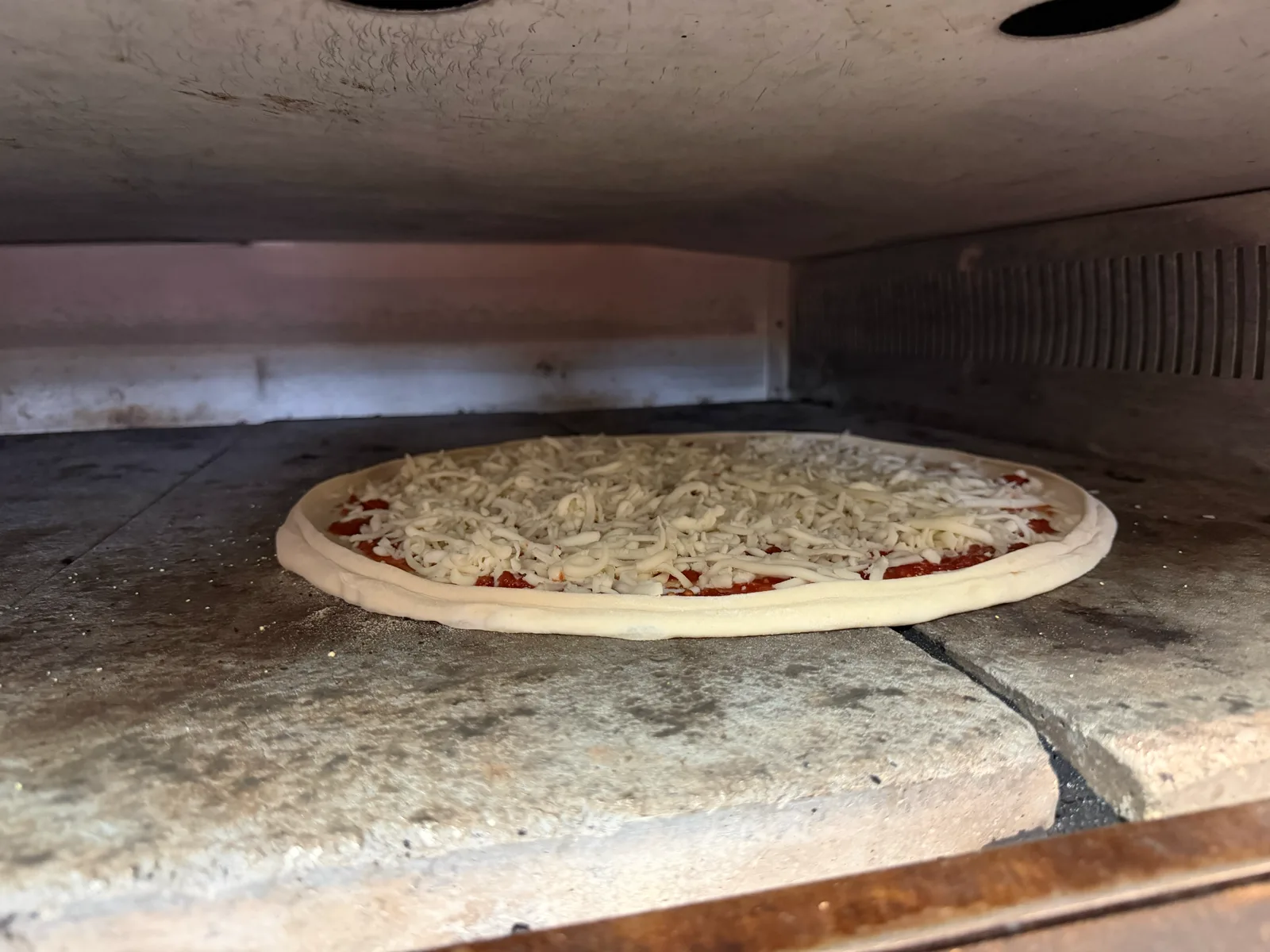 A pizza baking in the brick oven at Antonio's Easthampton