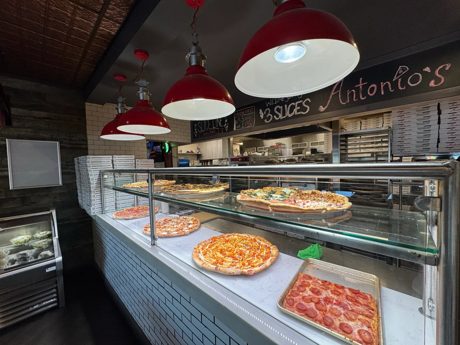 Slice display case with the $3 slice special at Antonio's Pizza Newport