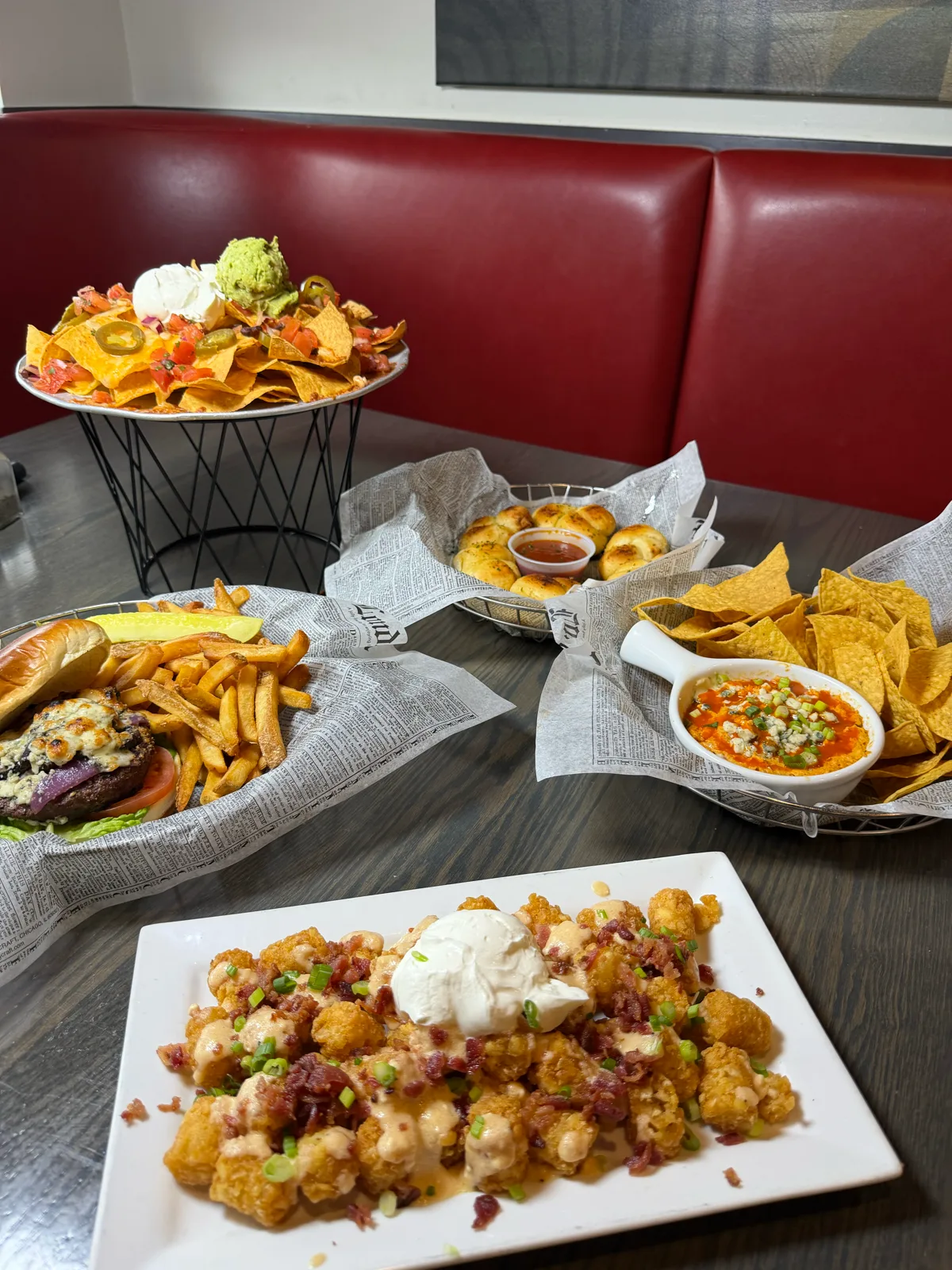 Nachos, a bacon blue cheese burger, chips with salsa, and loaded tots at Antonio's Pizza Newport