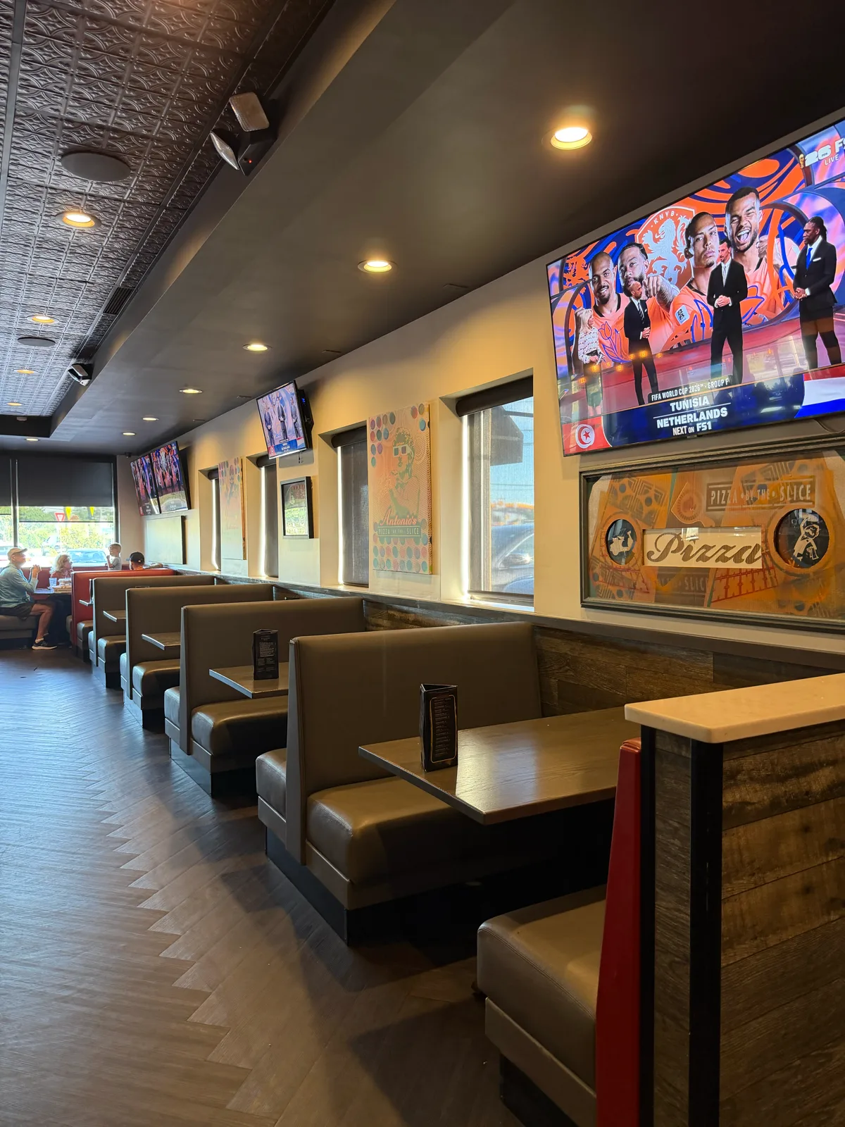 Booth seating with TVs at Antonio's Pizza Newport