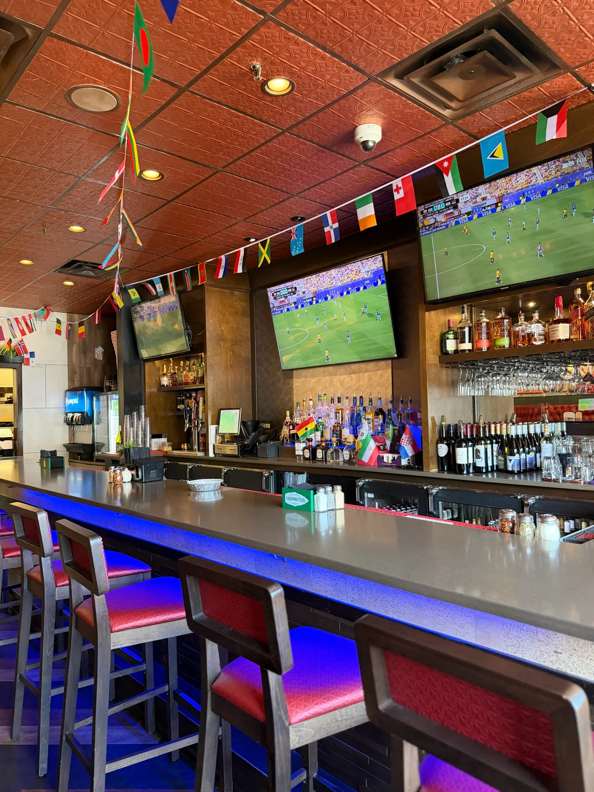 Bar seating under the TVs at Antonio's Pizza Pawtucket