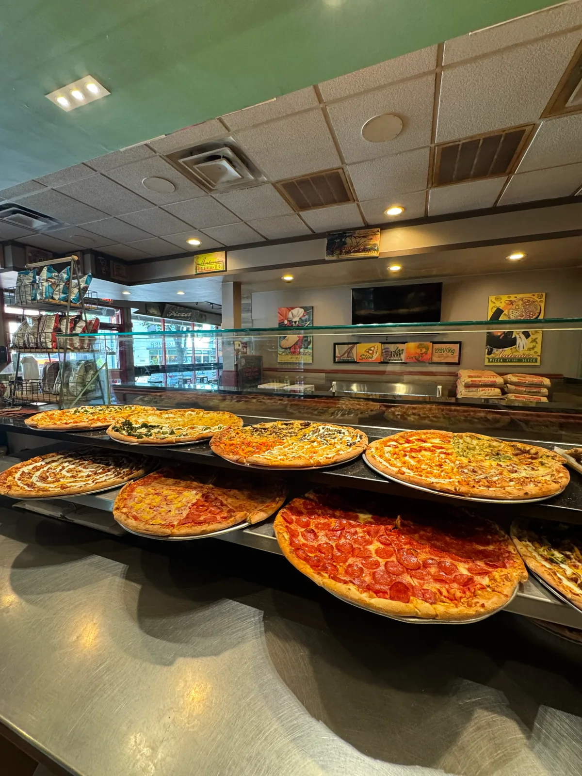 Slice case full of fresh whole pizzas at Antonio's Thayer Street
