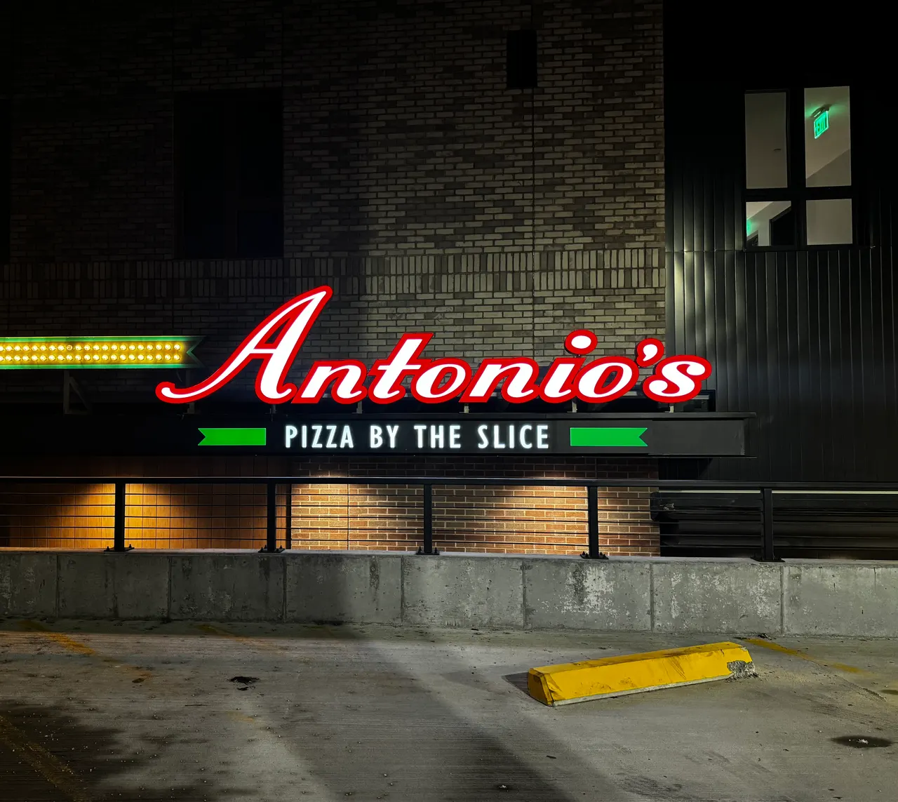 Antonio's Pizza by the Slice illuminated sign on Wickenden Street at night