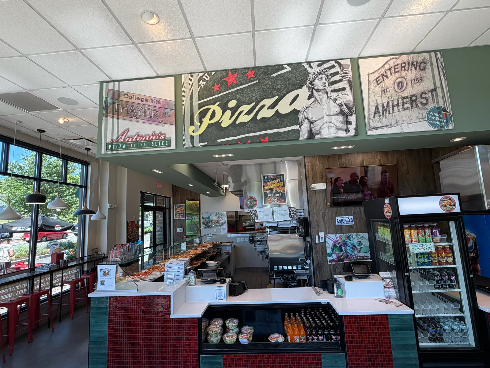 Order counter and the Pizza mural with Thayer Street and Amherst signs at Antonio's Wickenden