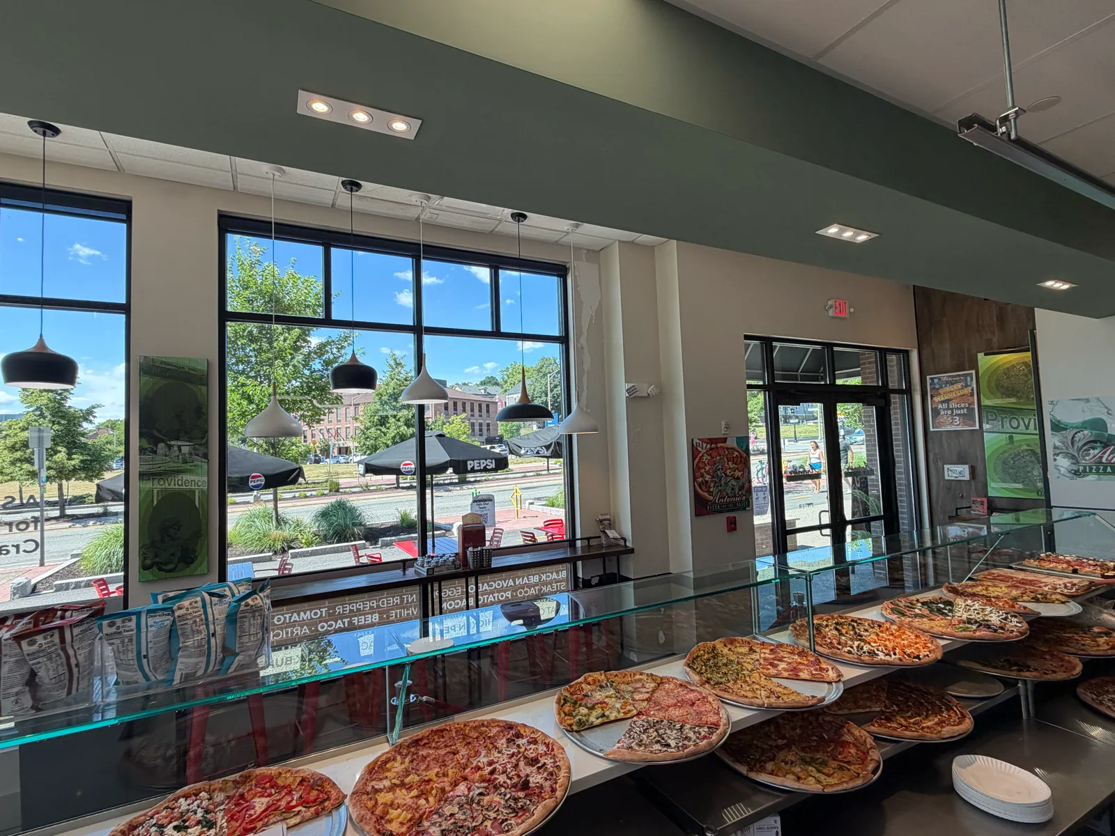 Slice line of whole pizzas along the counter at Antonio's Wickenden Street
