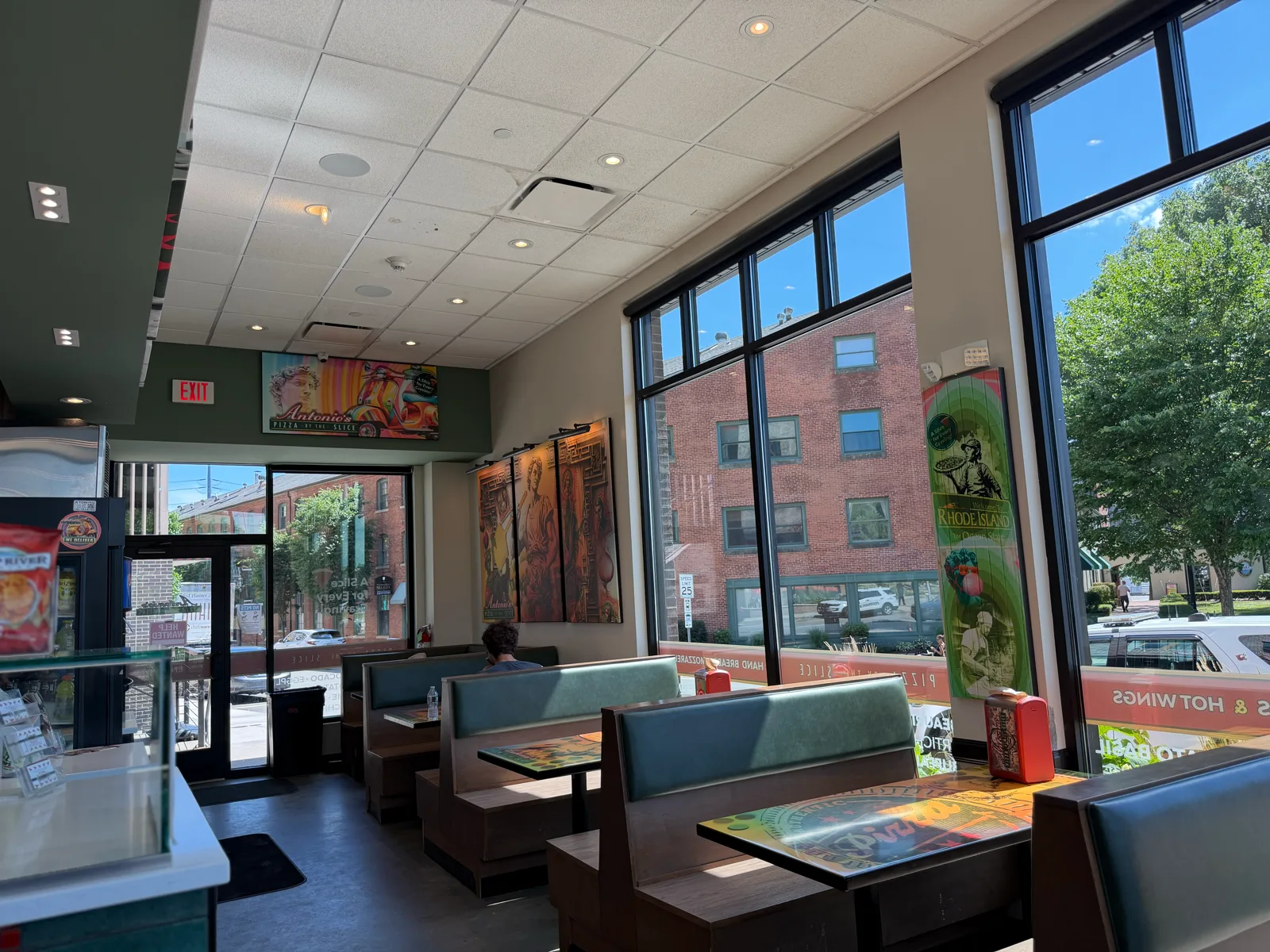 Green booth dining room with street-view windows at Antonio's Wickenden Street