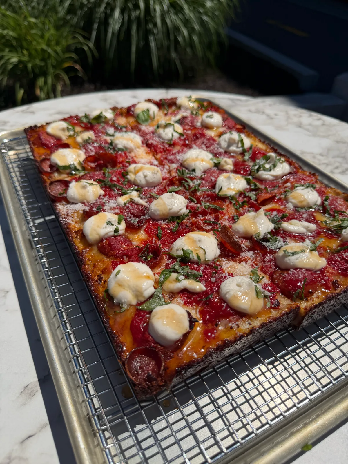 Detroit-style pepperoni pizza with fresh mozzarella and basil at Antonio's Wickenden Street