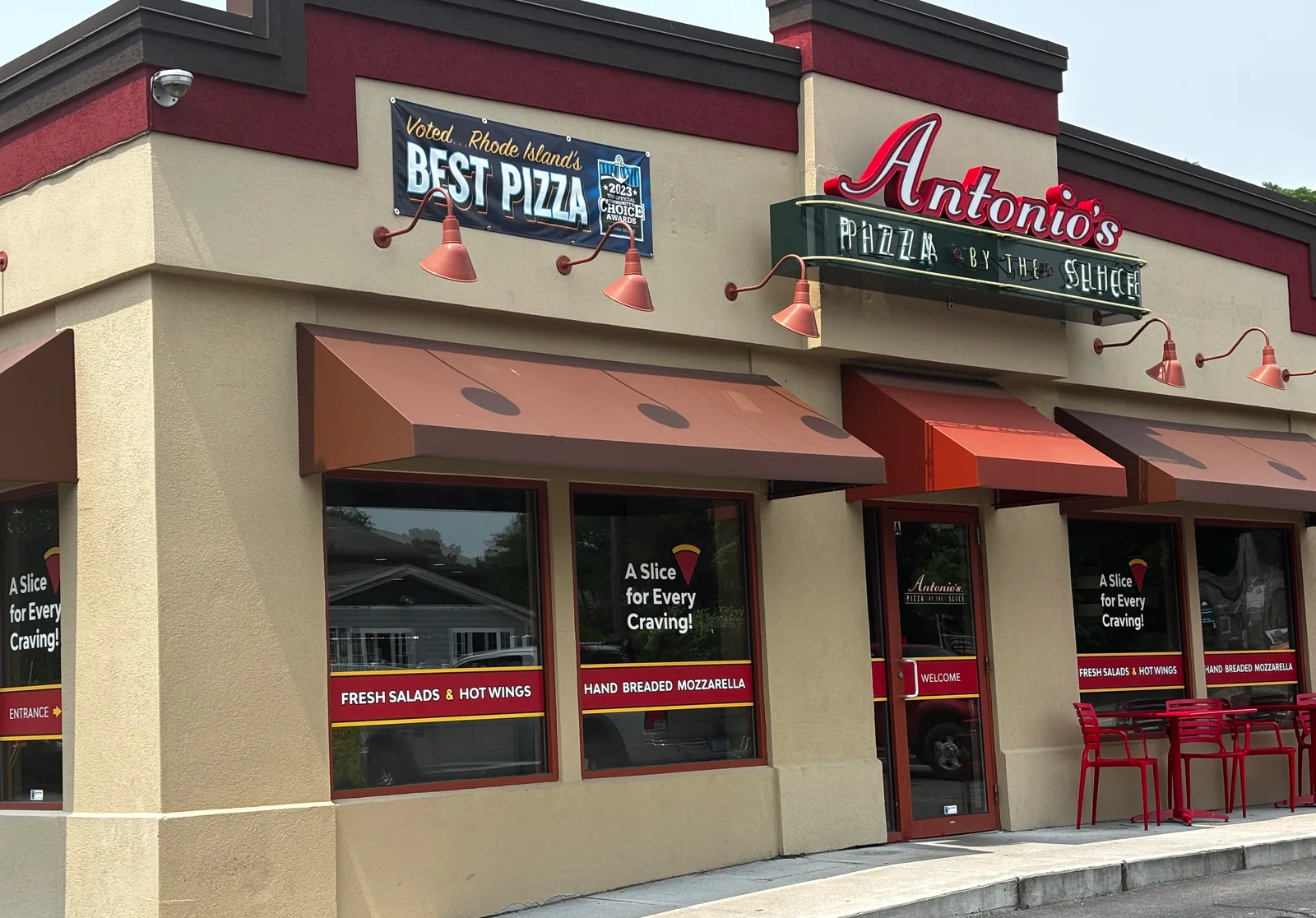 Antonio's Pizza by the Slice Wakefield storefront corner, with the Voted Rhode Island's Best Pizza banner and the green neon sign