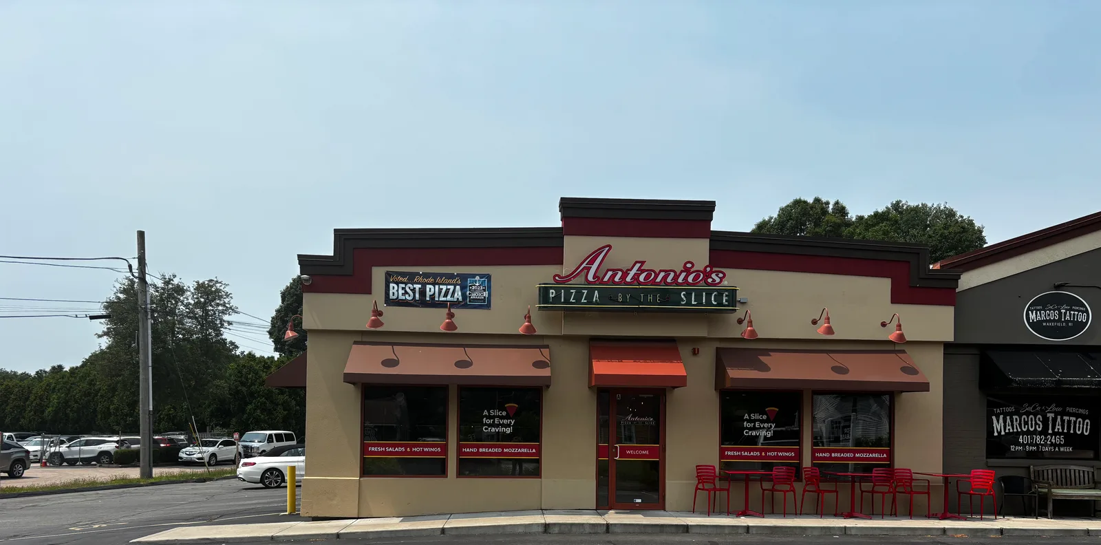Antonio's Pizza Wakefield storefront seen head-on from the Kingstown Road lot, beside Marcos Tattoo