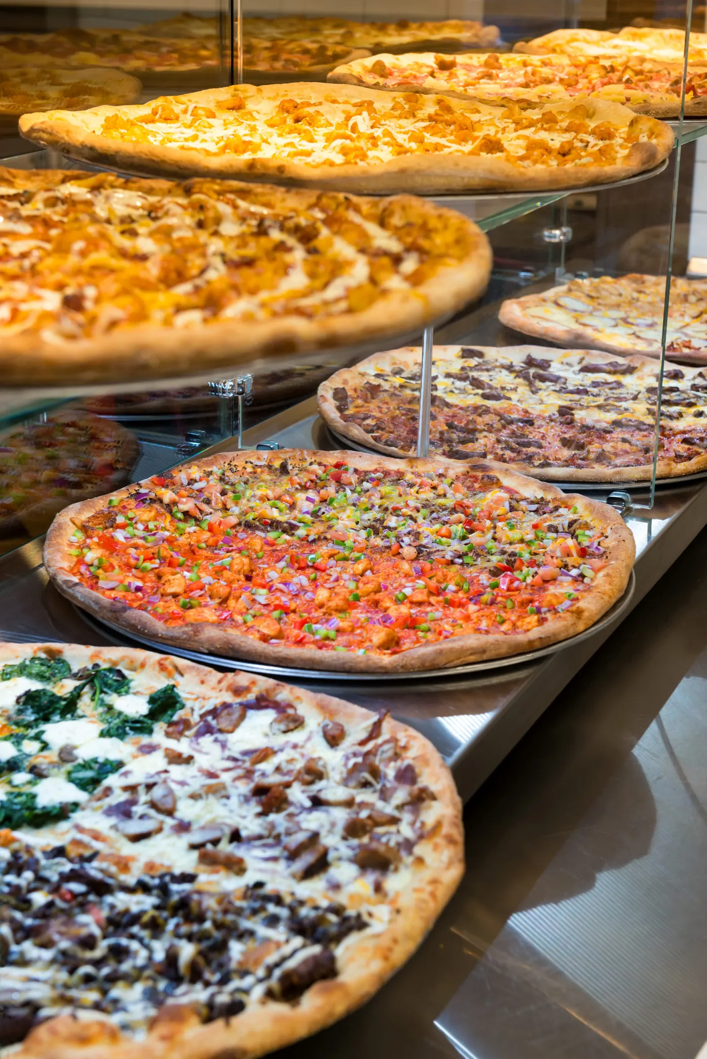 Antonio's pizza slice display with colorful pies