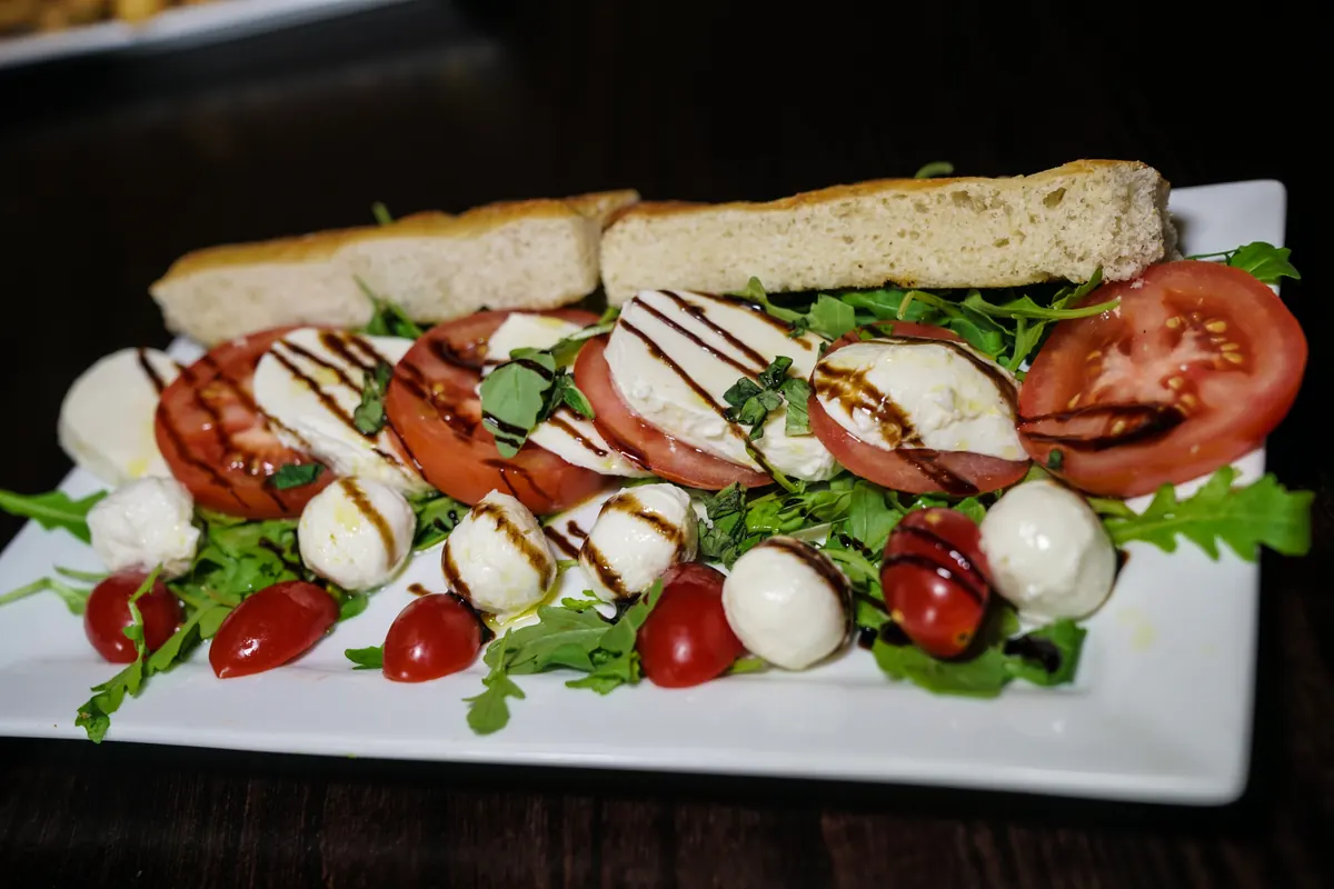 Antonio's caprese sandwich on a white plate
