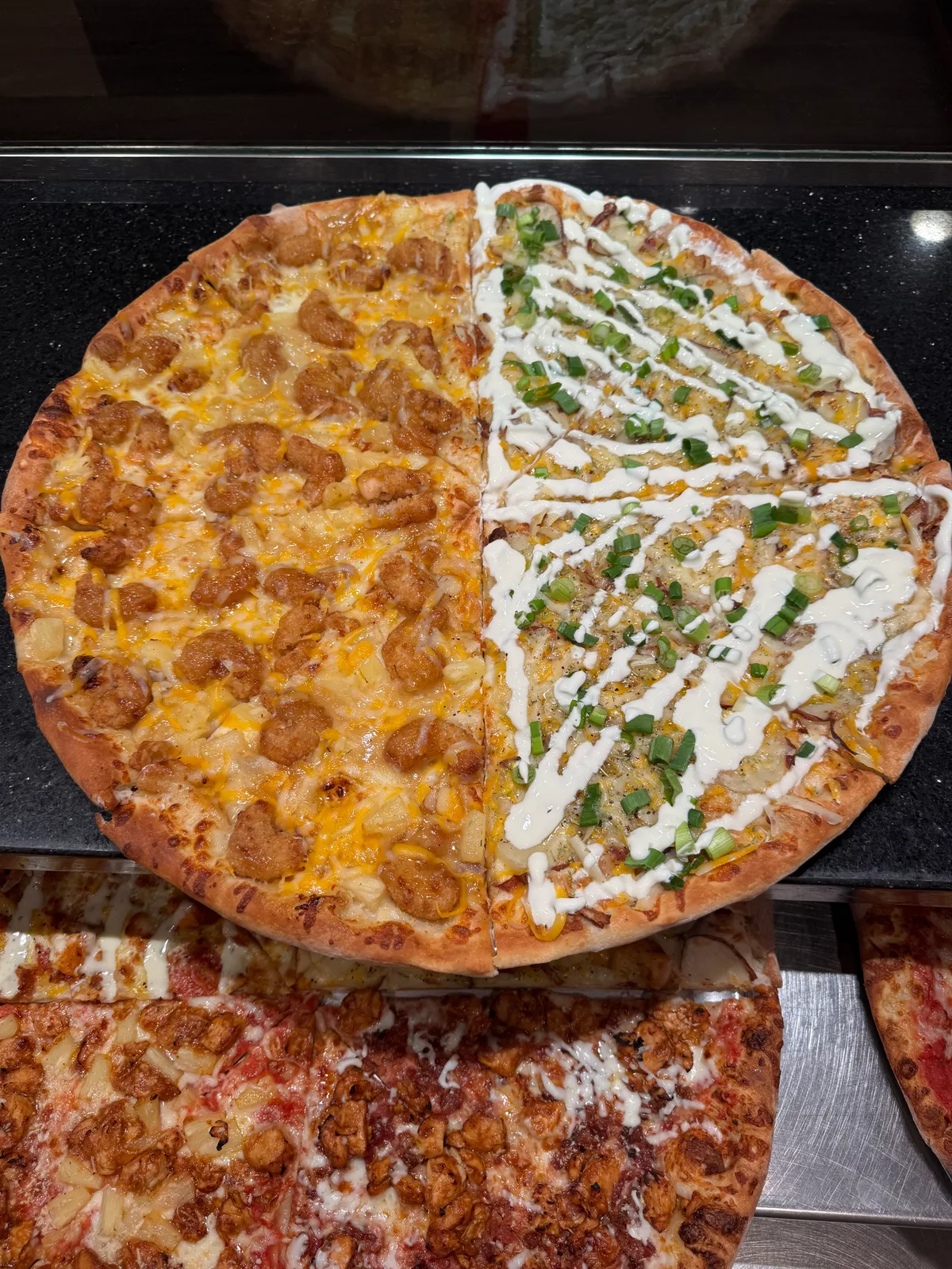 Antonio's buffalo chicken pizza, half drizzled with ranch