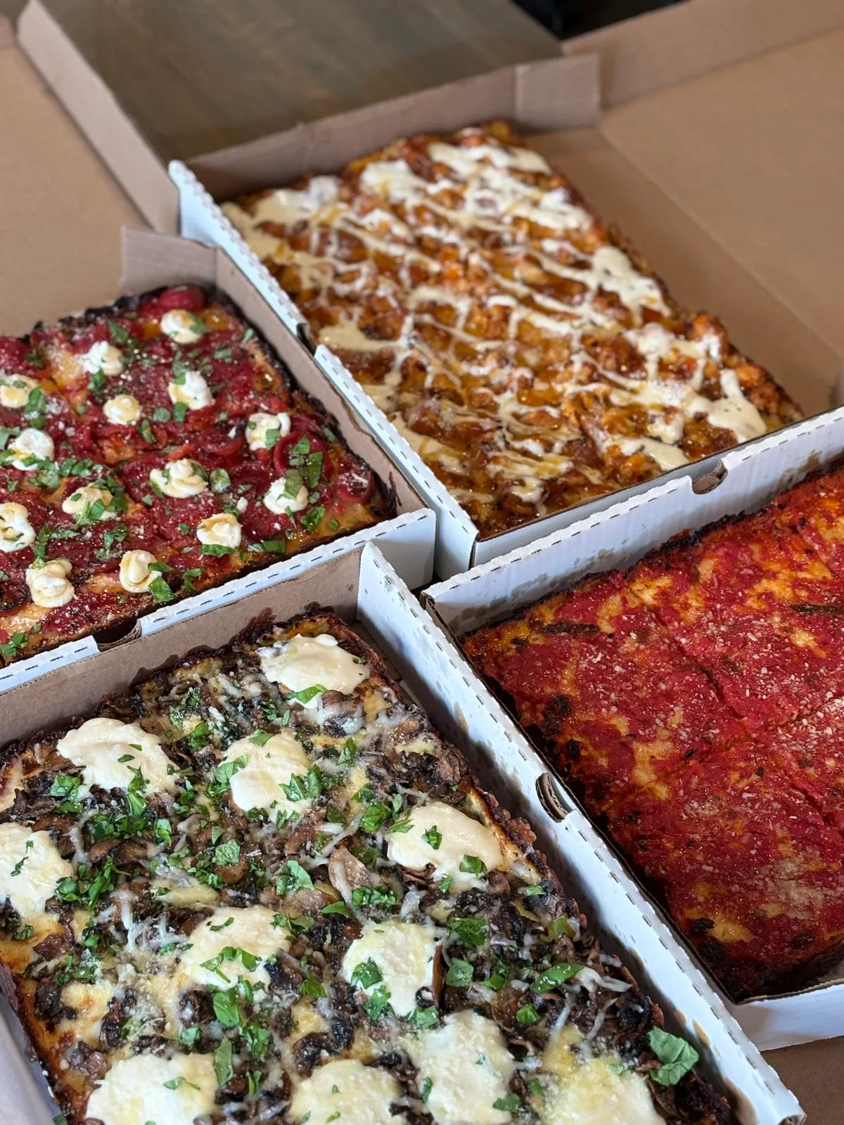 Boxed Antonio's Sicilian pizzas ready for takeout